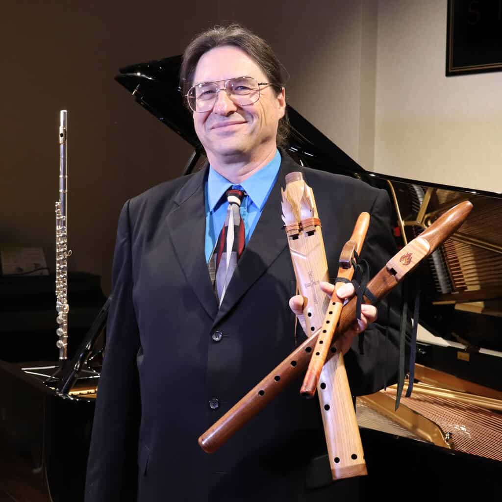 Jim holding Native American Flutes